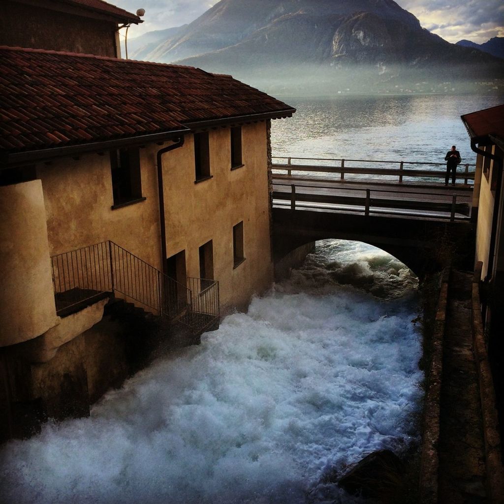 SEA BY BUILDINGS AGAINST SKY