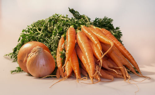 Close-up of carrots and onions on table