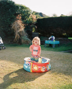 Cute boy standing in ball pool