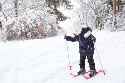 Full length of children on snow covered land