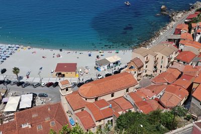 High angle view of buildings by sea