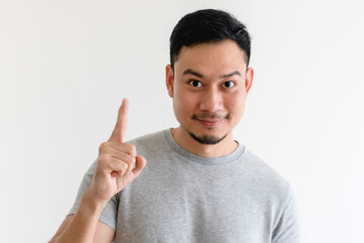 Portrait of mid adult man wearing hat against white background