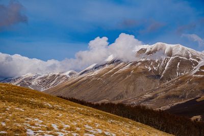 Scenic view of snowcapped mountains against sky