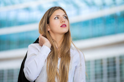 Portrait of beautiful young woman standing outdoors