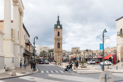 View of city street and buildings against sky