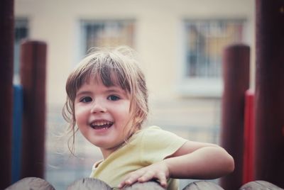 Portrait of cute cheerful girl playing at playground