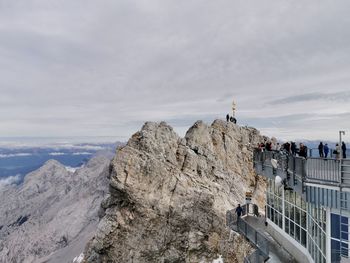 People on mountain against sky