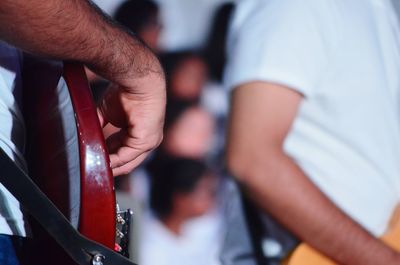 Close-up of man playing guitar