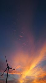 Windmill with sky in background at sunset