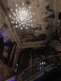 Low angle view of illuminated ceiling in abandoned building