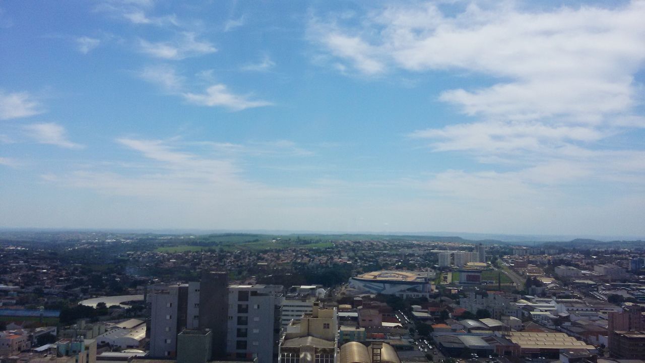 cityscape, building exterior, city, architecture, built structure, crowded, sky, high angle view, residential district, cloud - sky, aerial view, residential building, residential structure, cloud, city life, skyscraper, outdoors, no people, day, cloudy