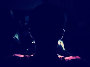 Full length of woman in dark room