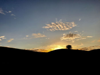 Scenic view of silhouette landscape against sky at sunset