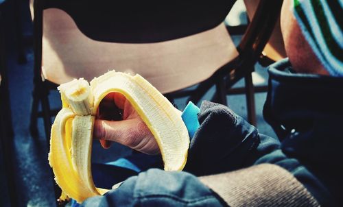 Close-up of man holding banana