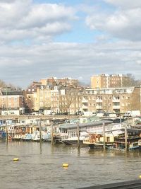 Boats in river with buildings in background
