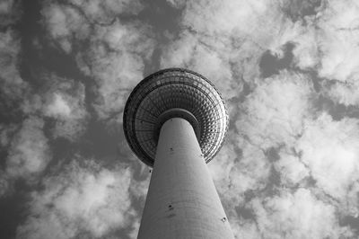 Low angle view of fernsehturm tower against cloudy sky