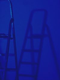 Close-up of illuminated lamp against blue sky