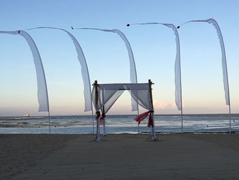 Lifeguard hut on beach against clear sky