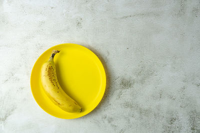 High angle view of yellow fruit on table against wall