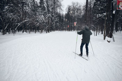 Man skiing on snow covered field