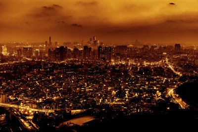 Aerial view of city lit up at night