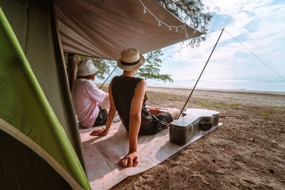 Asian musician couple playing guitar with happiness and joyful from honeymoon activity in summer