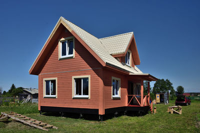 Exterior of house on field against sky