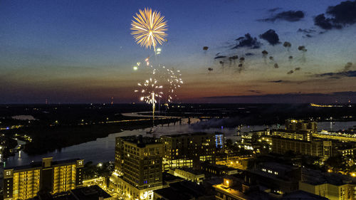 Firework display over city at night