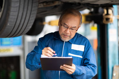 Mid adult man working at auto repair shop