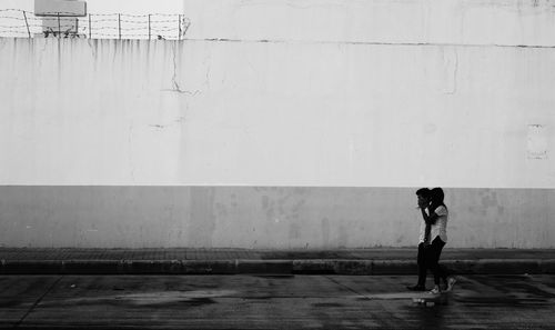 Woman standing against water