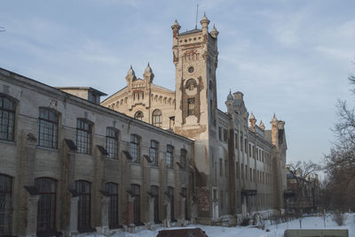 Historic building against sky during winter