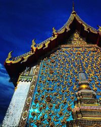 Low angle view of temple building against blue sky