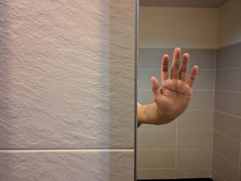 Reflection of human hand seen in mirror