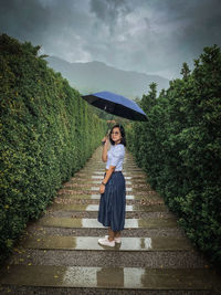 Rear view of woman walking on footpath