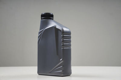 Close-up of bottle on table against white background