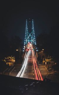 High angle view of light trails on bridge at night