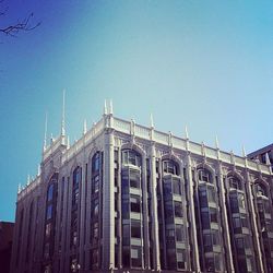 Low angle view of buildings against clear blue sky