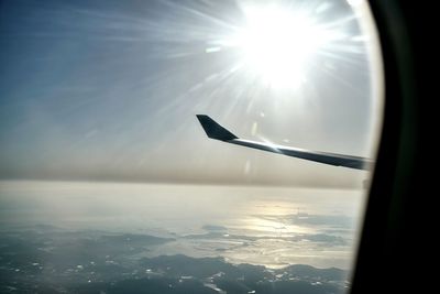 Idyllic view of sun over sea seen from airplane window