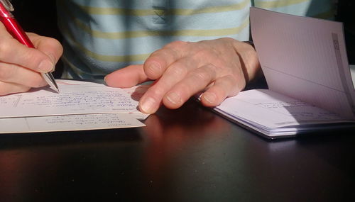 Midsection of man working on table