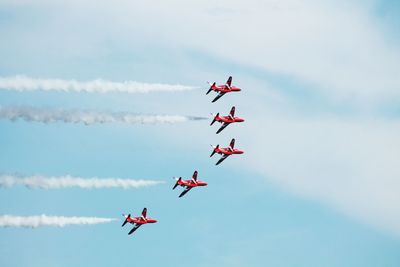 Low angle view of airshow against sky