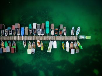 High angle view of boats moored at harbor on sea