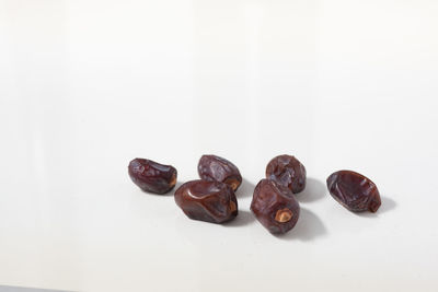 Close-up of coffee beans against white background