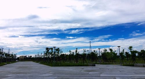 Road amidst trees against sky