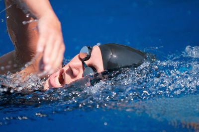 High angle view of mid adult woman swimming in pool