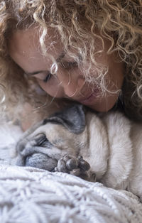 Close-up of a dog lying on bed