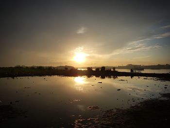 Scenic view of lake against sky during sunset