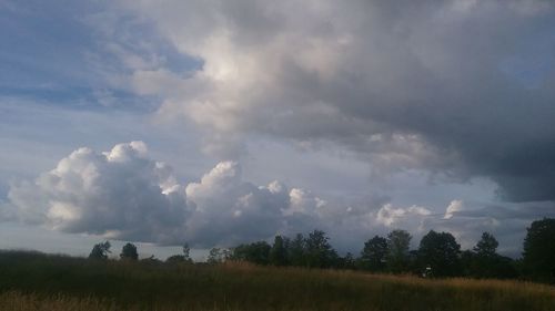 Scenic view of agricultural field against storm clouds