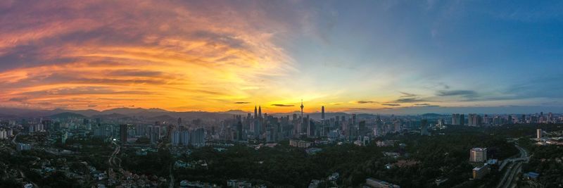 Panoramic view of city against sky during sunset