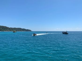 Scenic view of sea against clear blue sky