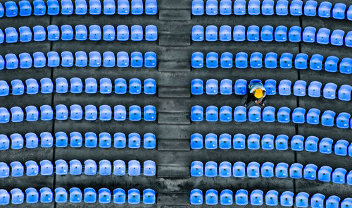 High angle view of man sitting on chair in stadium